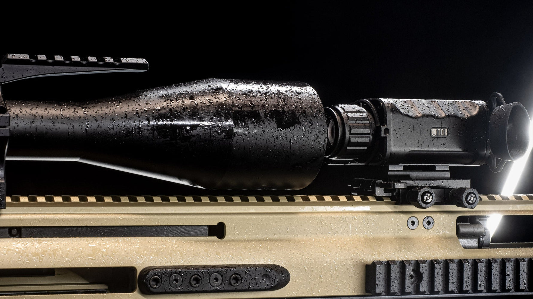 TDX Thermal optic mounted as a clip-on to another scope, sitting in light rain
