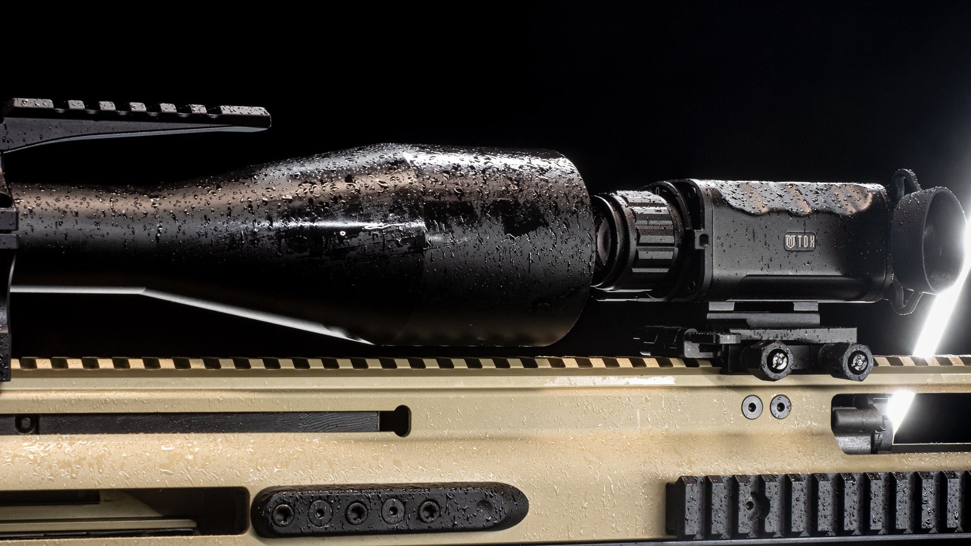 TDX Thermal optic mounted as a clip-on to another scope, sitting in light rain